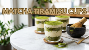 Eggless matcha tiramisu cups layered with creamy filling and sponge cake dusted with matcha powder.